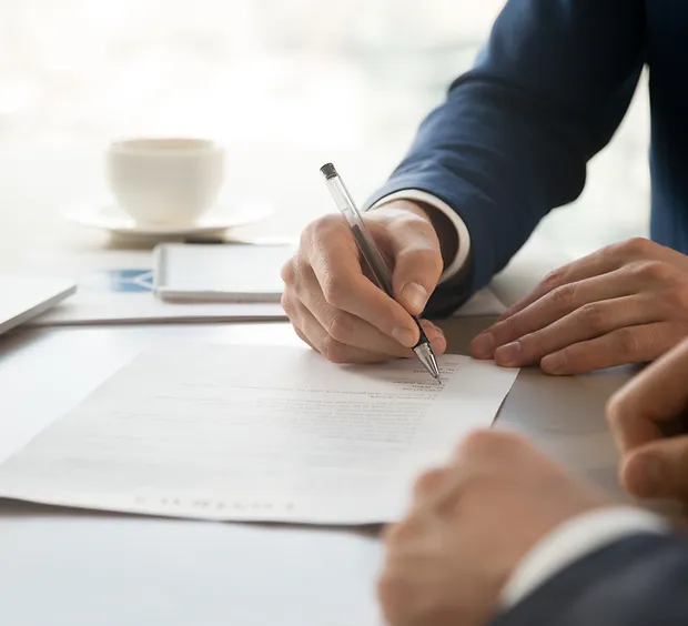 Man-in-Suit-Signing